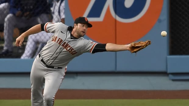 Aug 7, 2020; Los Angeles, California, USA; San Francisco Giants first baseman Darin Ruf (33) can t reach a double hit by Los Angeles Dodgers center fielder Cody Bellinger (35) in the third inning of the game at Dodger Stadium. Mandatory Credit: Jayne Kamin-Oncea-USA TODAY Sports